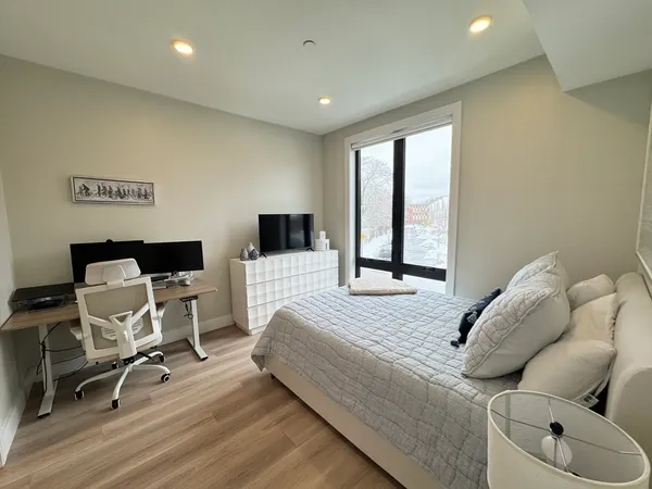 a bedroom with a bed and wooden floor
