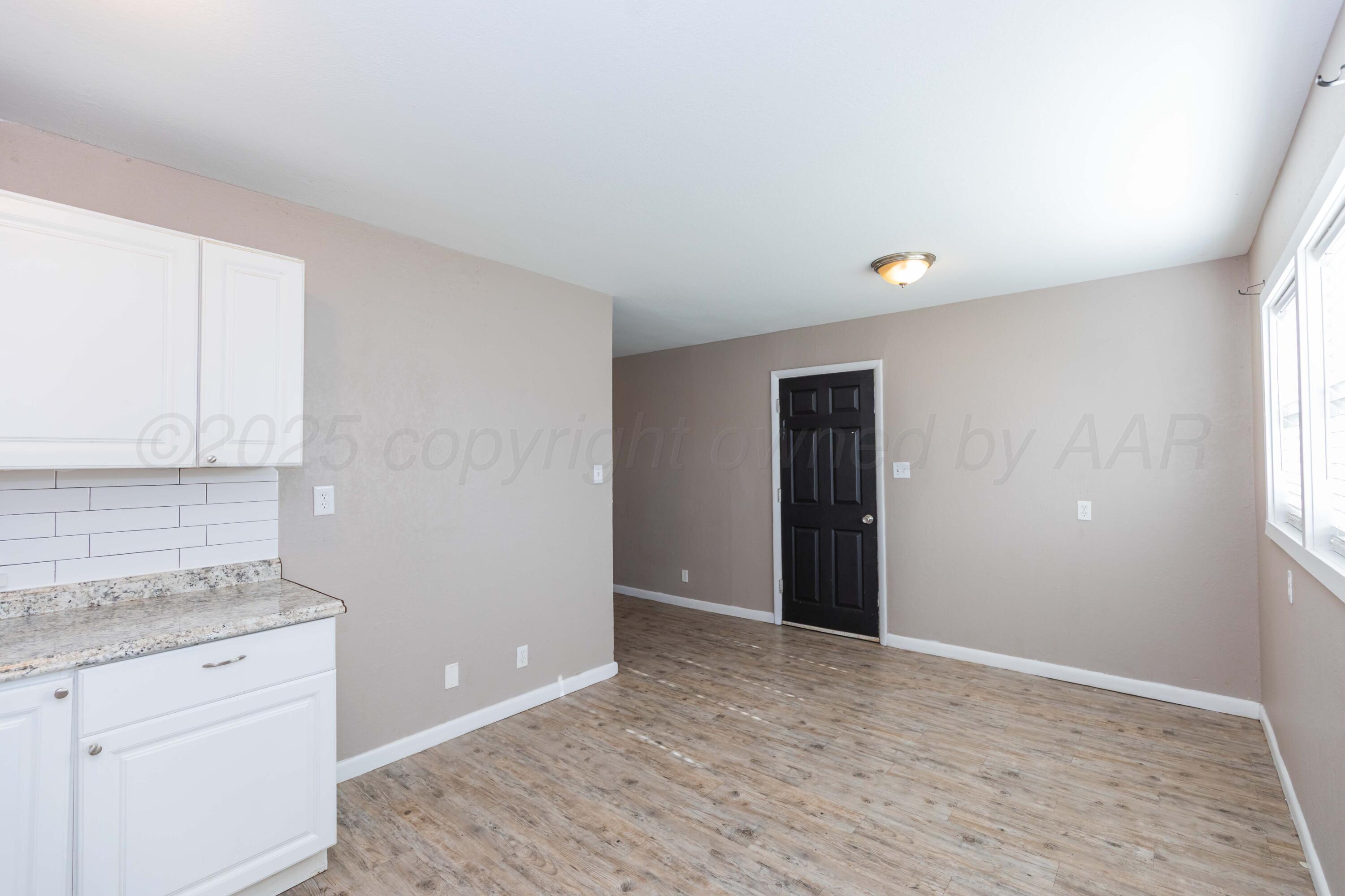 2138 North Sumner Street Pampa, TX 79065 - Photo 12 of 30 an empty room with windows and cabinet