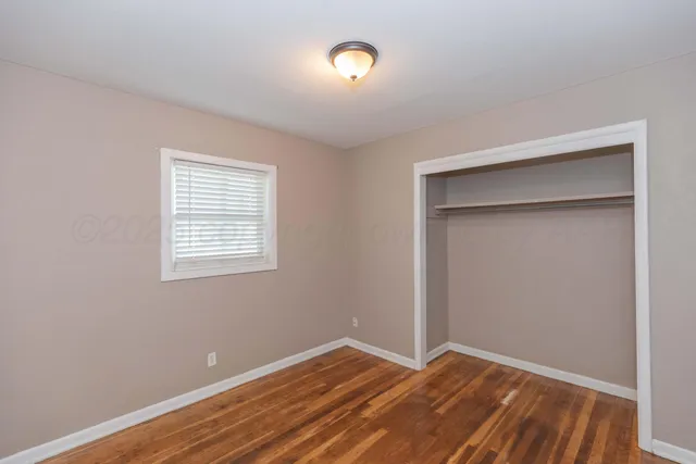 a view of room with hardwood floor and window