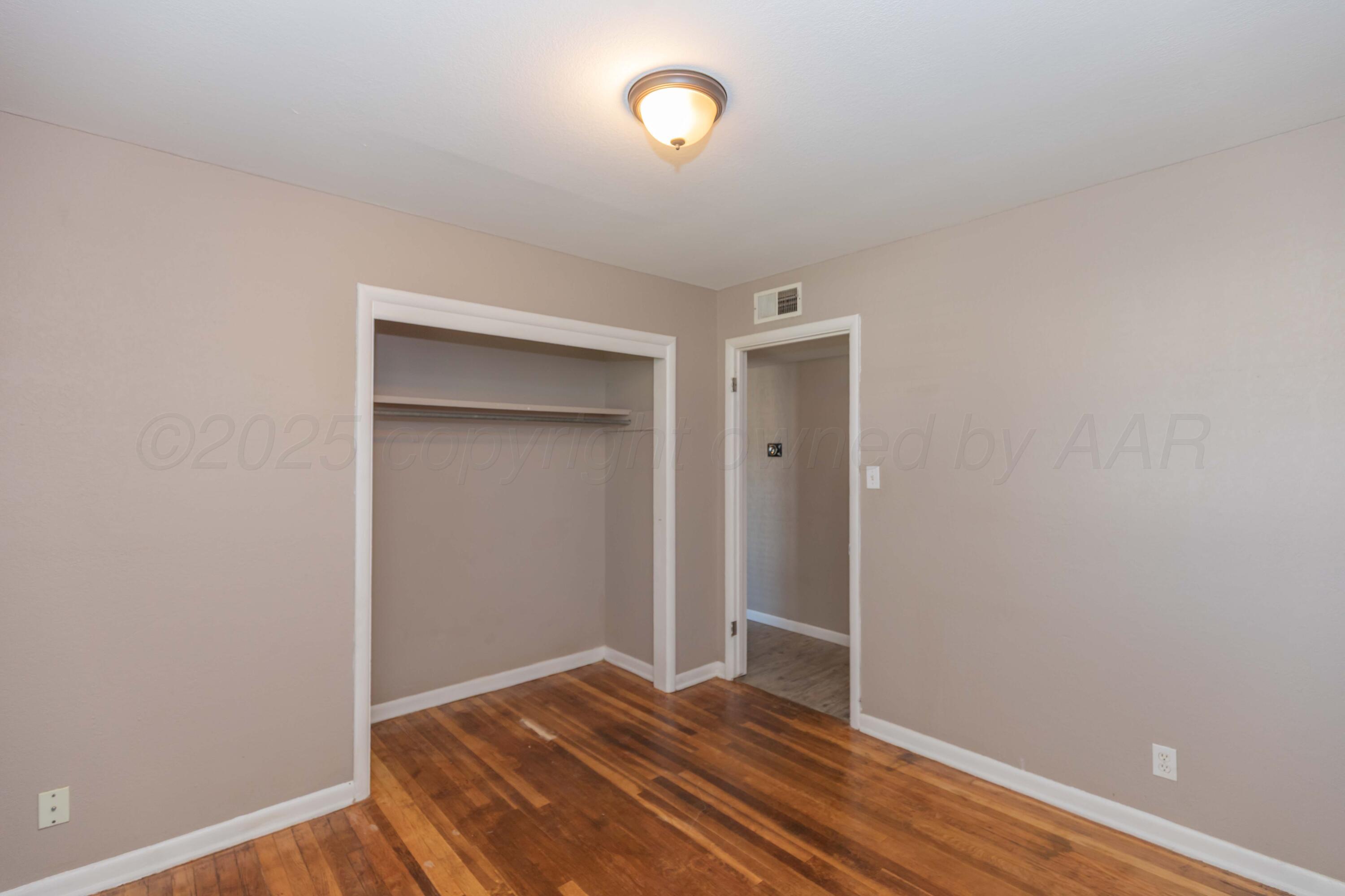 2138 North Sumner Street Pampa, TX 79065 - Photo 15 of 30 a view of room with wooden floor