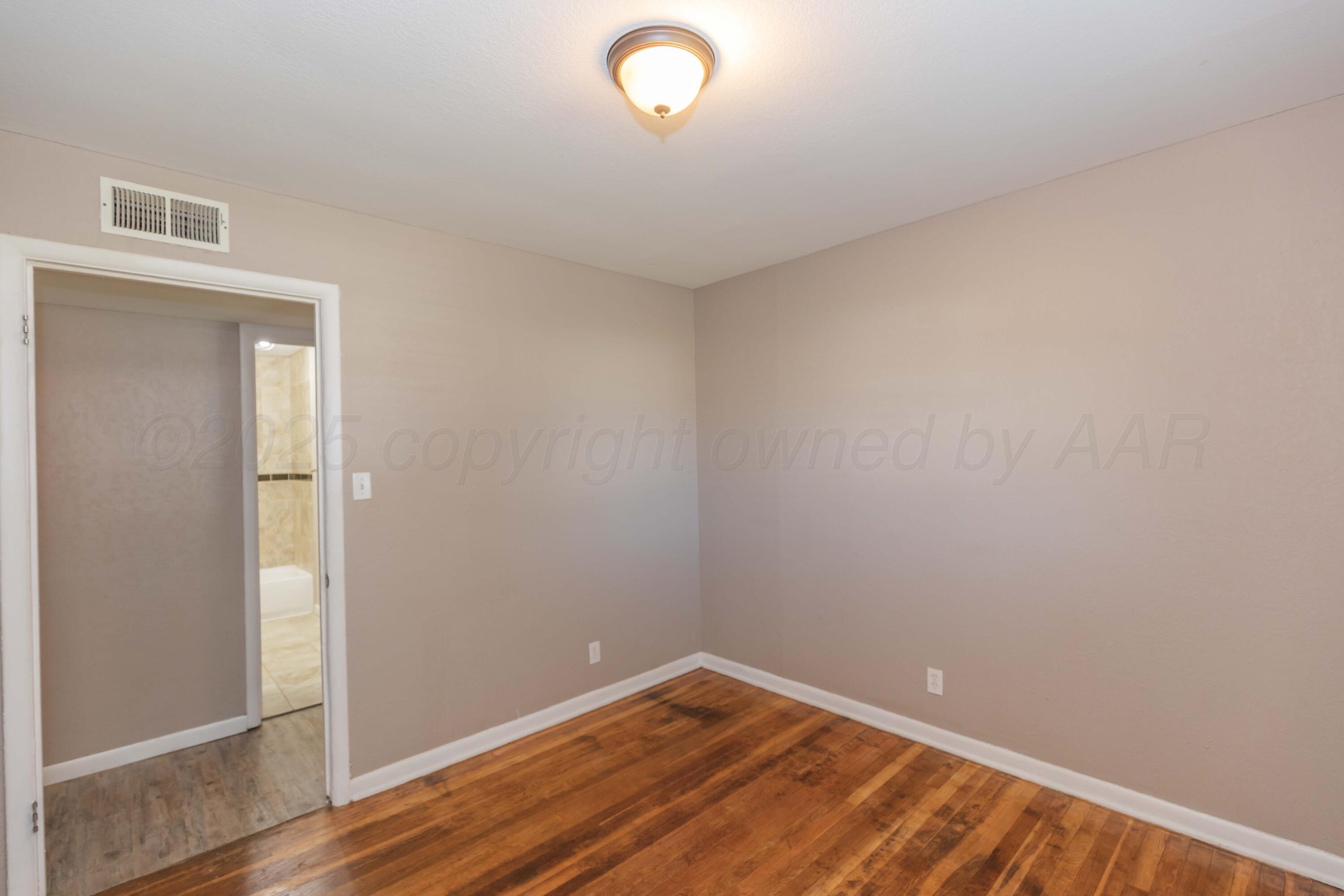 2138 North Sumner Street Pampa, TX 79065 - Photo 16 of 30 a view of room with wooden floor