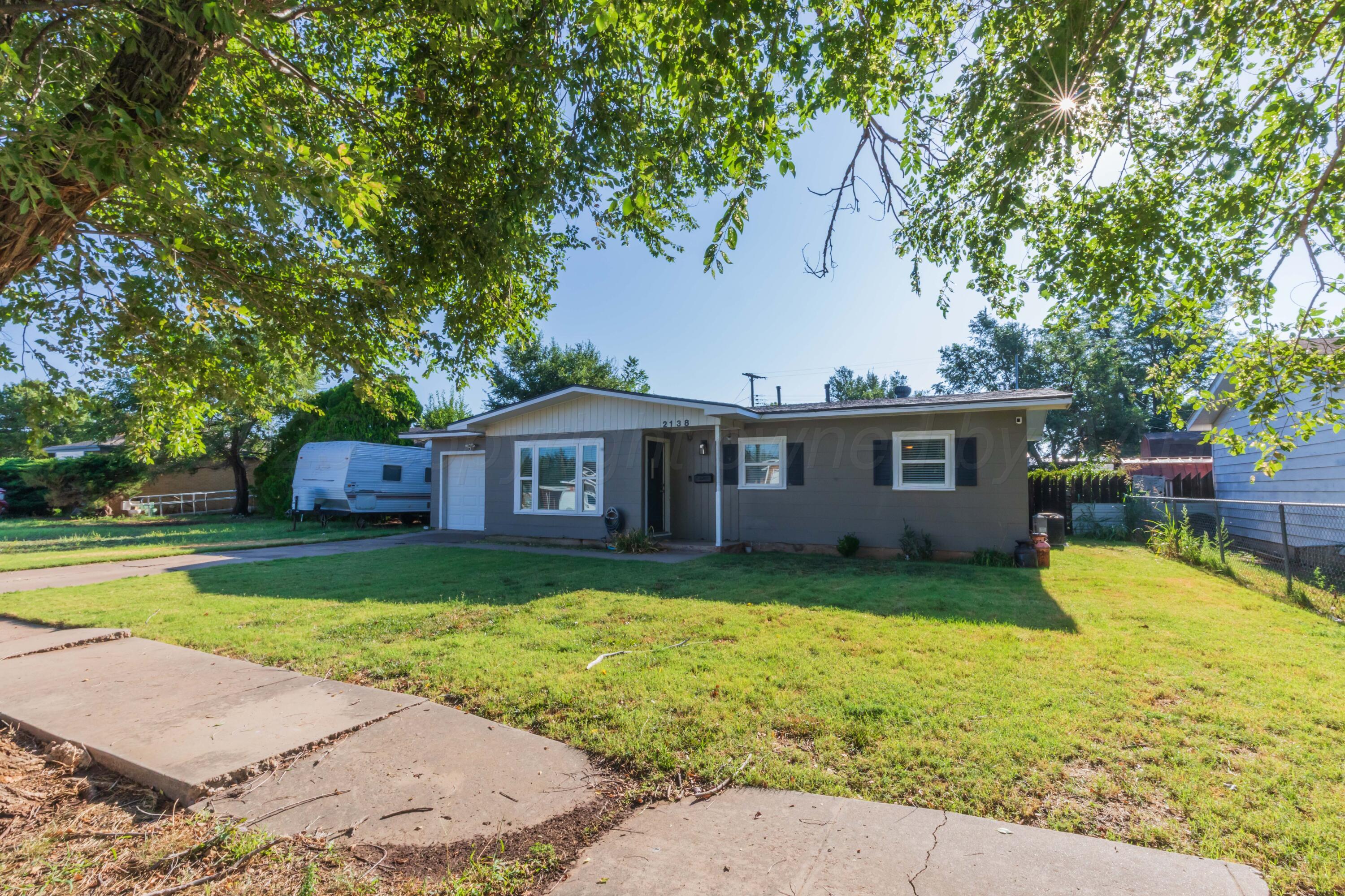 2138 North Sumner Street Pampa, TX 79065 - Photo 2 of 30 a front view of a house with garden