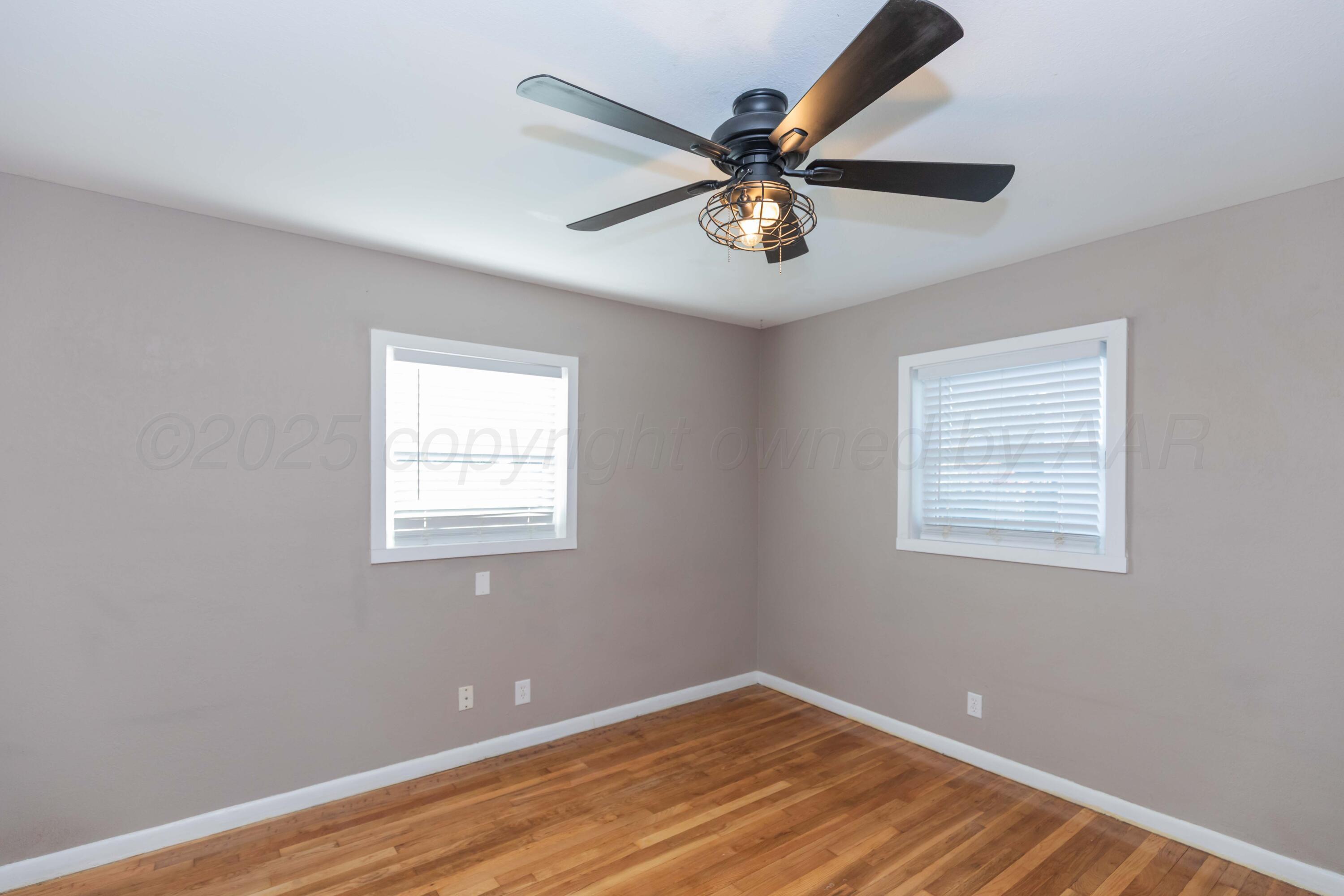 2138 North Sumner Street Pampa, TX 79065 - Photo 23 of 30 a view of a big room with wooden floor and windows