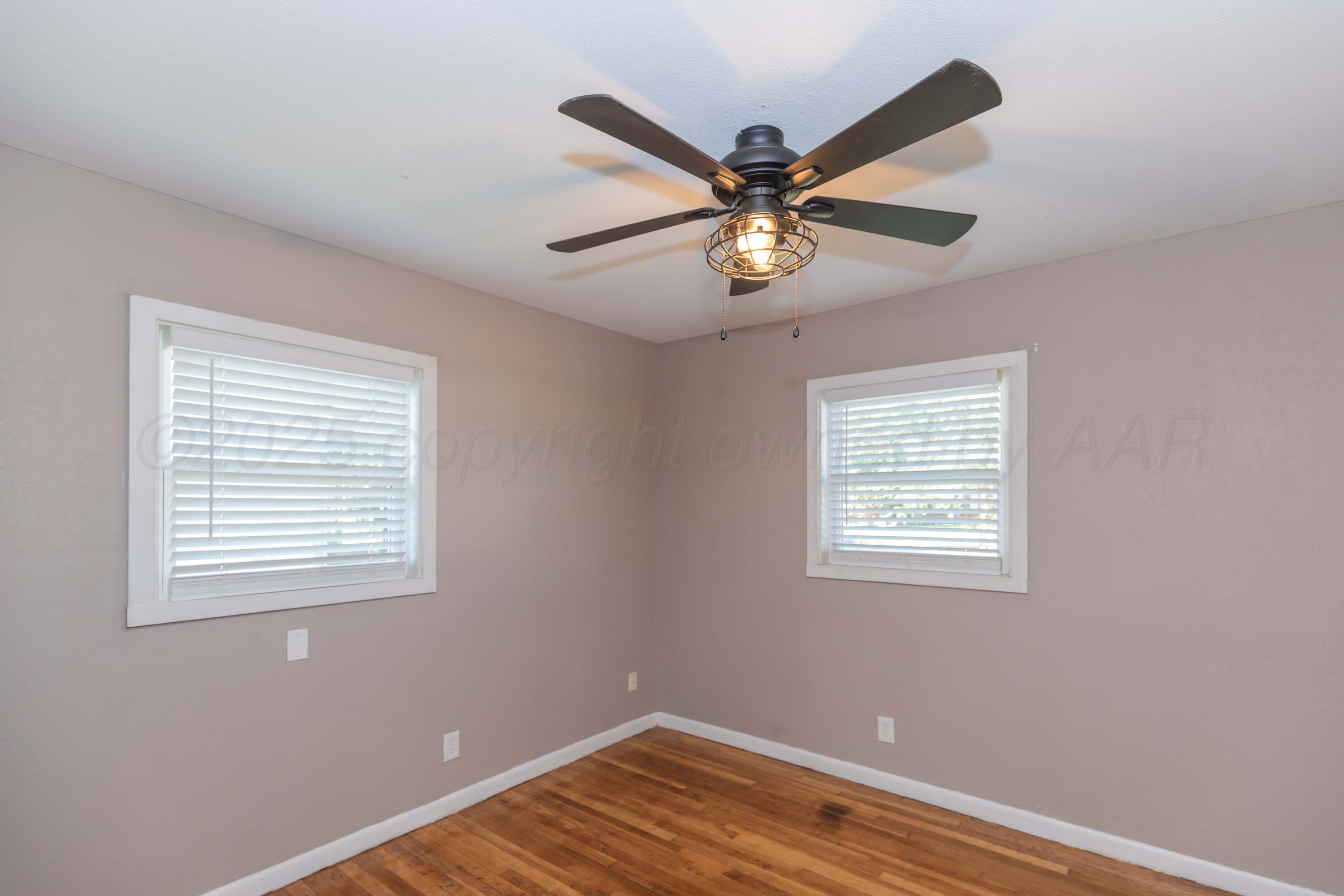 2138 North Sumner Street Pampa, TX 79065 - Photo 24 of 30 a view of an empty room with window and wooden floor