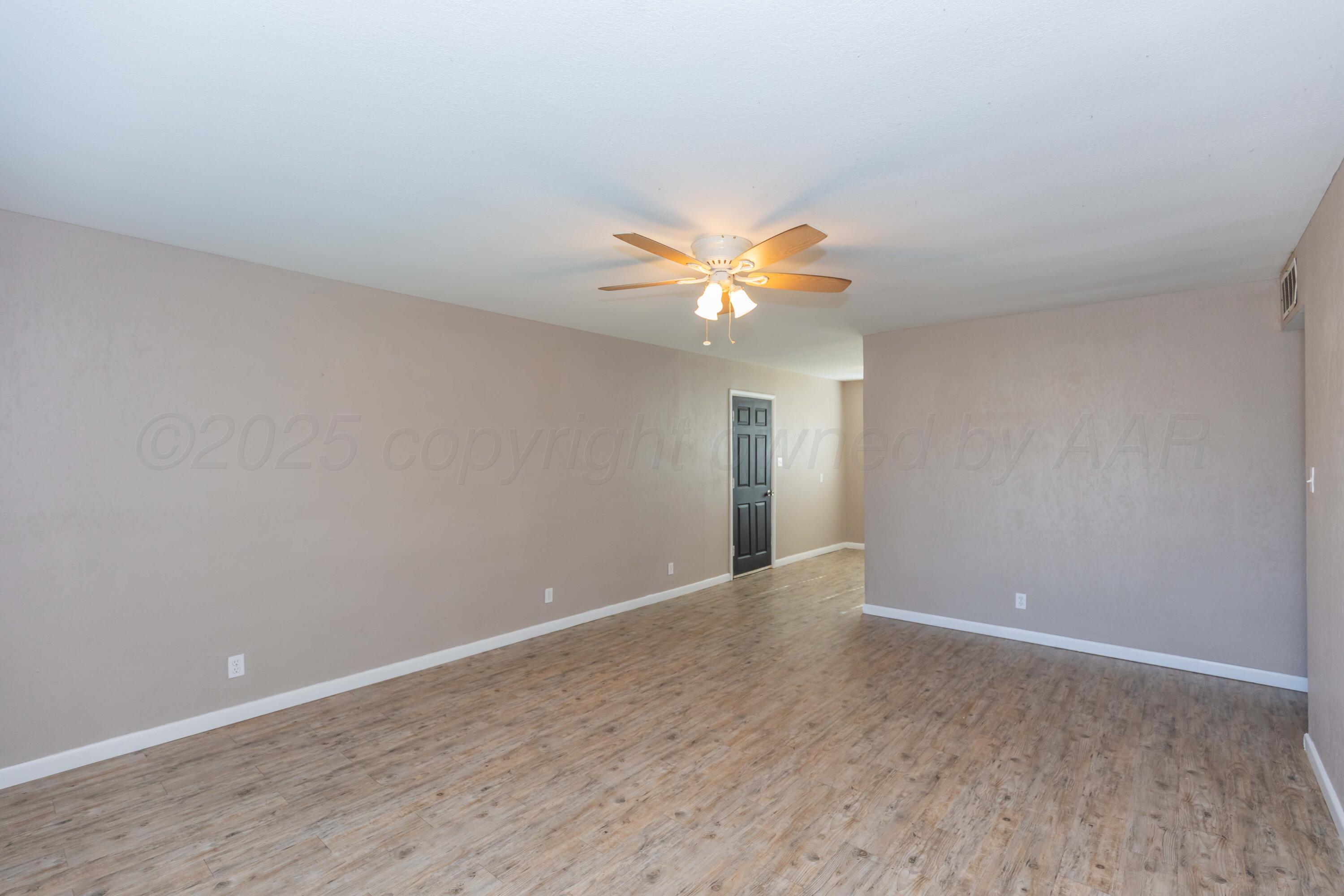 2138 North Sumner Street Pampa, TX 79065 - Photo 6 of 30 a view of an empty room with a chandelier fan