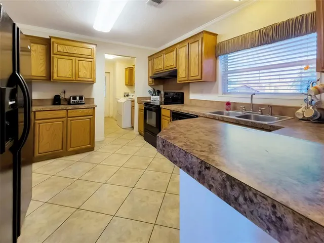 a kitchen with stainless steel appliances granite countertop a sink and cabinets