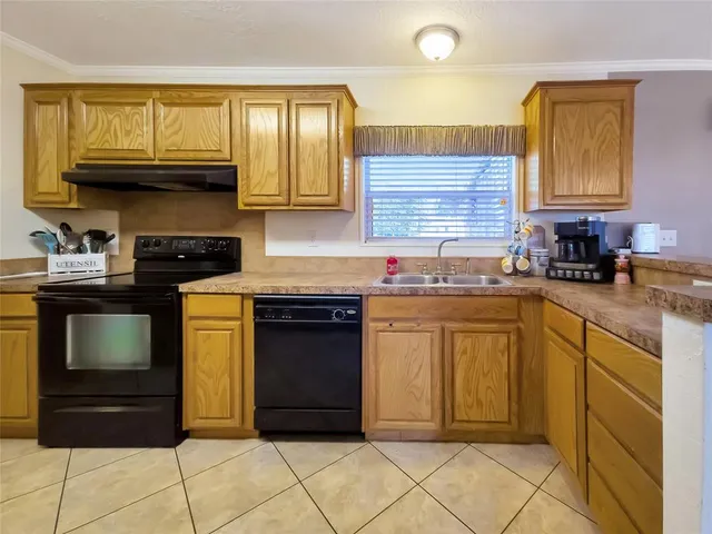 a kitchen with sink cabinets and window