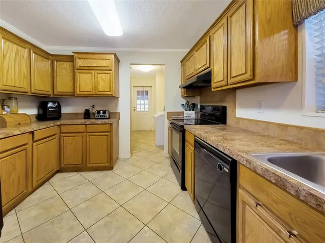 a kitchen with stainless steel appliances granite countertop a sink and cabinets