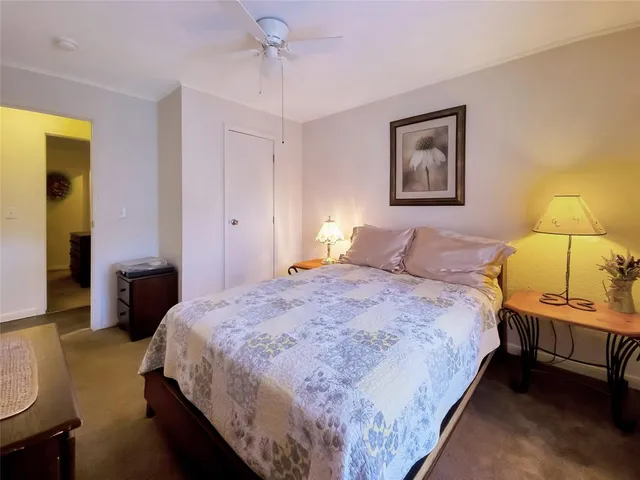 a bedroom with a bed and a lamp