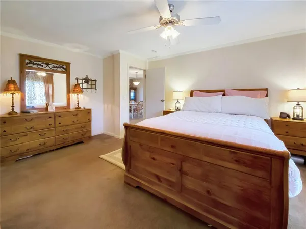 a room with a bed and dresser