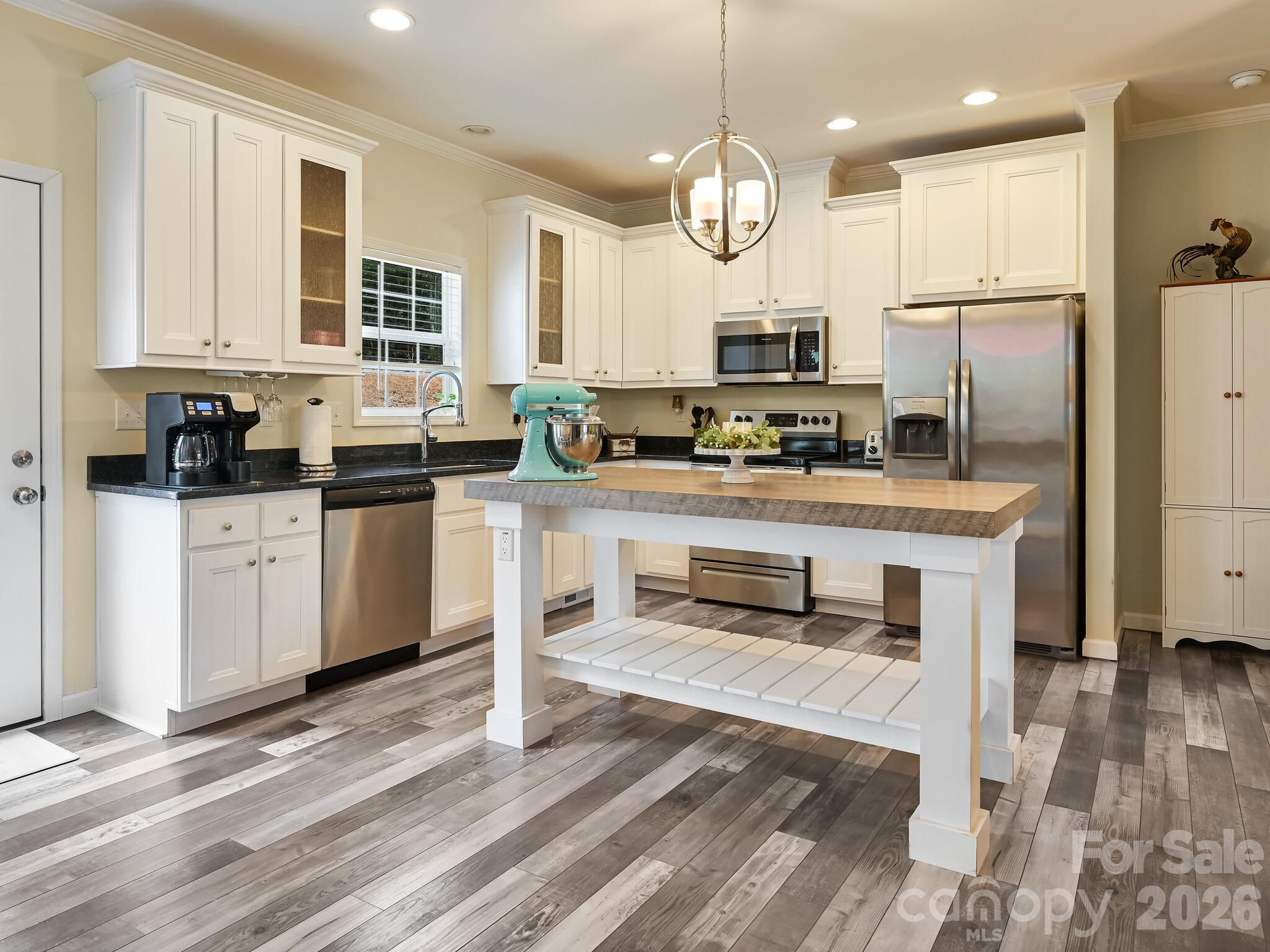 241 West Sunset Ridge Drive Etowah, NC 28729 - Photo 13 of 30 a kitchen with stainless steel appliances granite countertop a sink refrigerator and cabinets