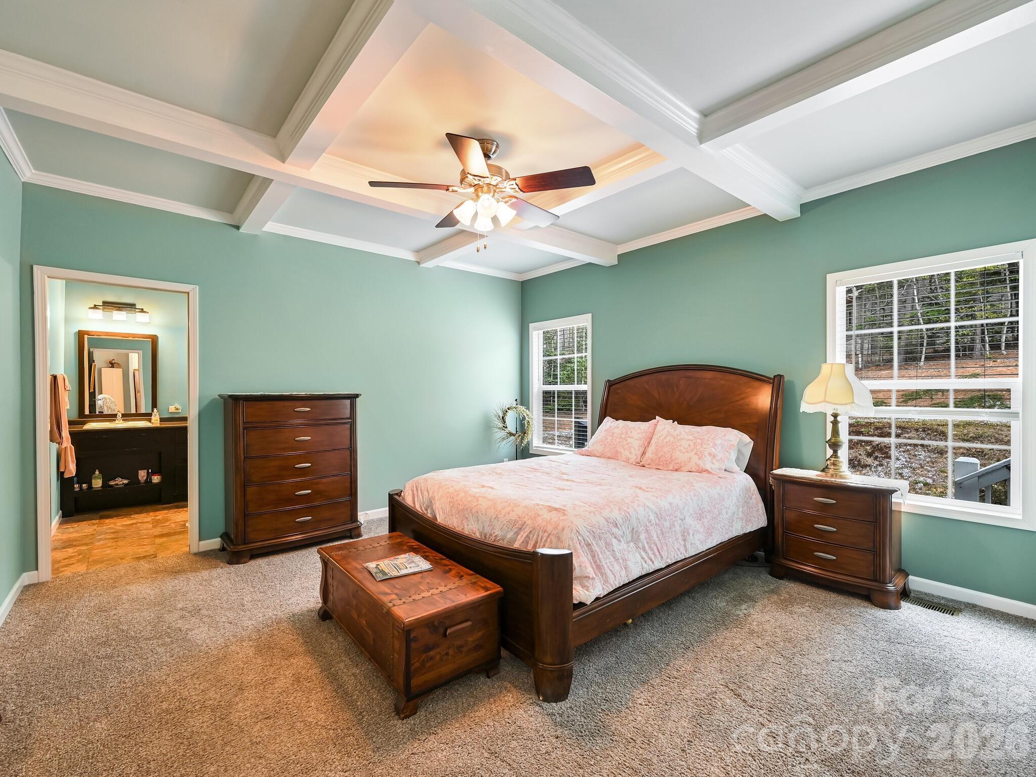 241 West Sunset Ridge Drive Etowah, NC 28729 - Photo 16 of 30 a bedroom with a bed and a chandelier