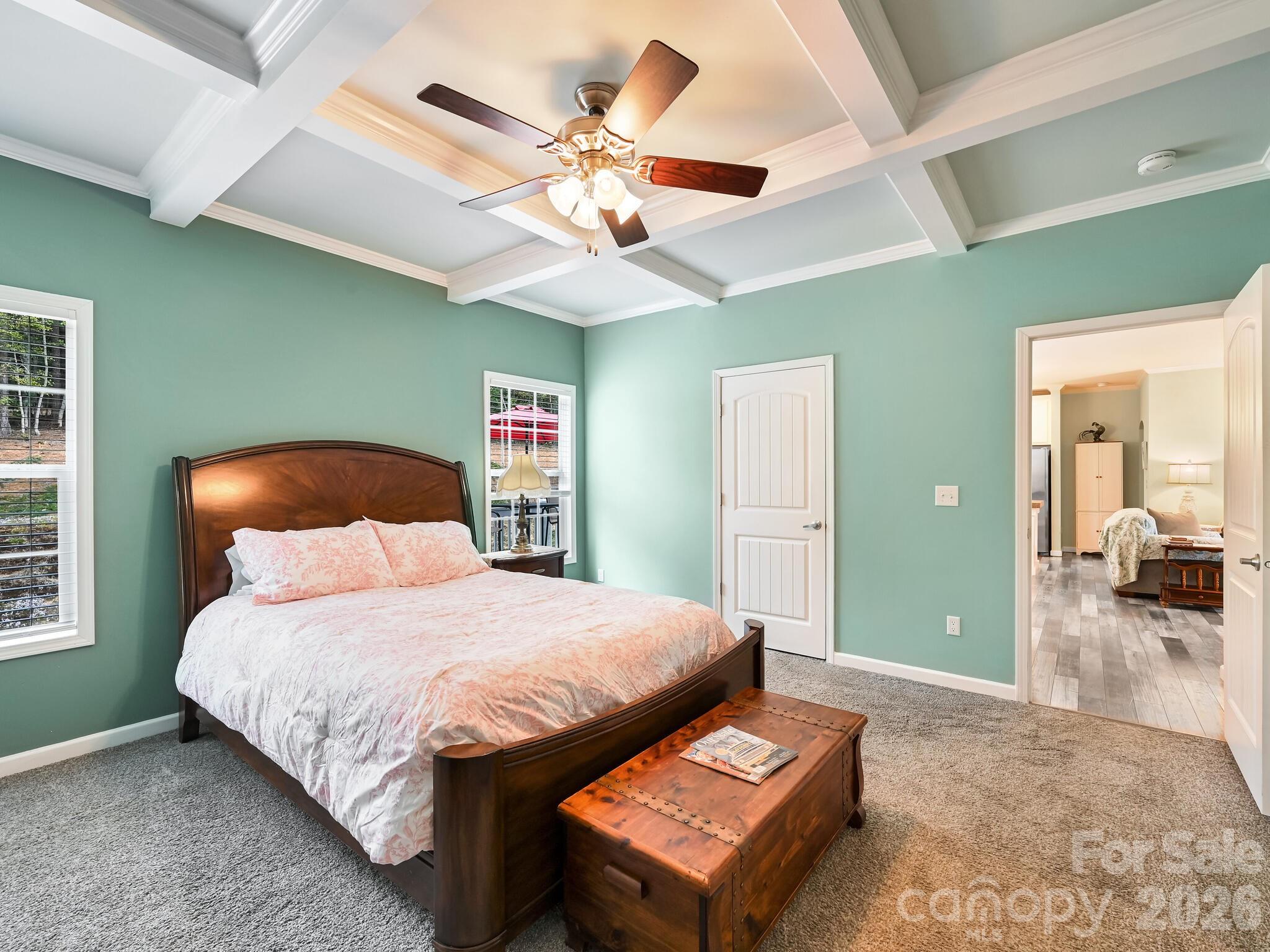 241 West Sunset Ridge Drive Etowah, NC 28729 - Photo 17 of 30 a bedroom with a bed and a chandelier