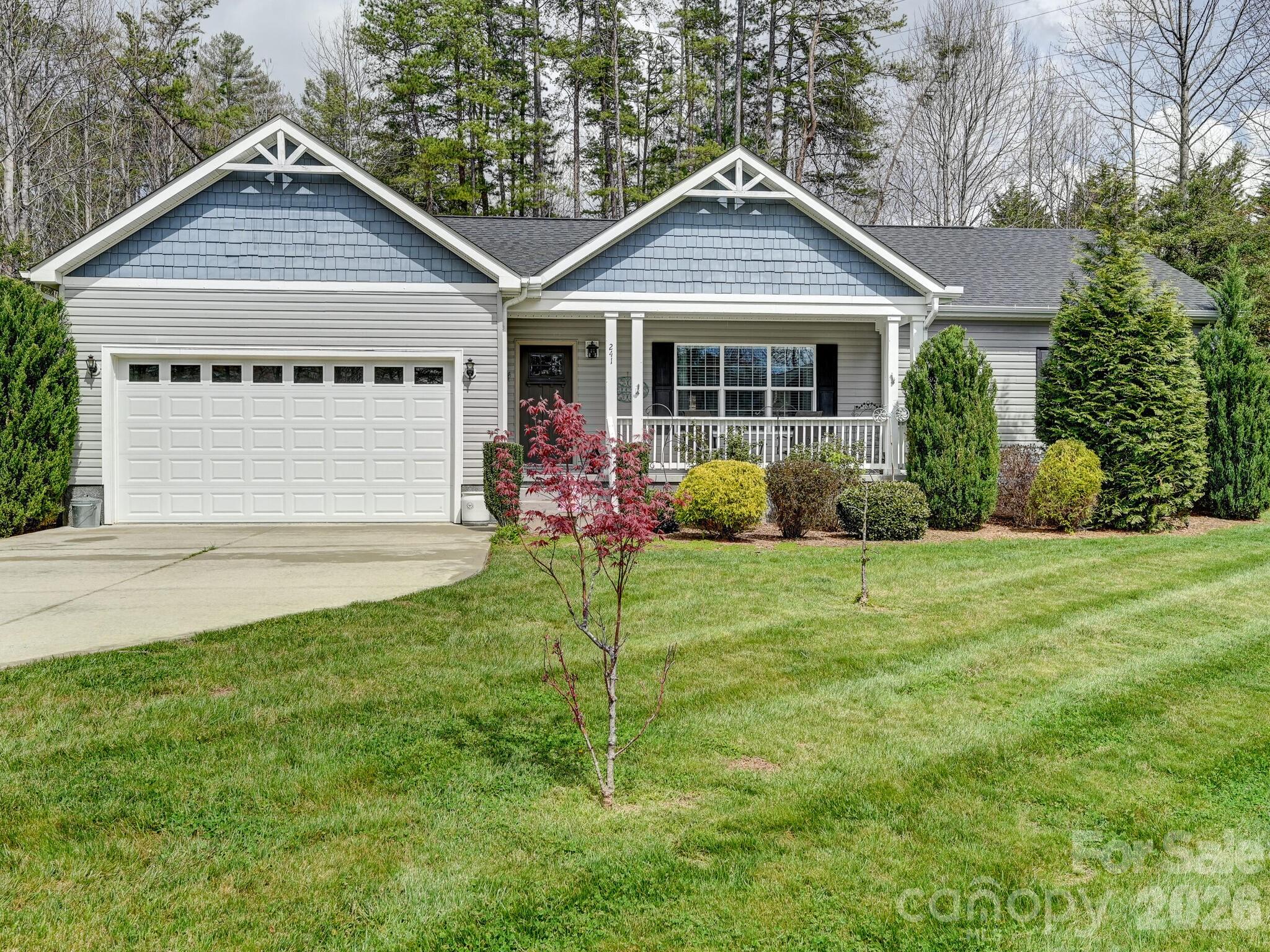 241 West Sunset Ridge Drive Etowah, NC 28729 - Photo 2 of 30 a front view of a house with a yard and porch