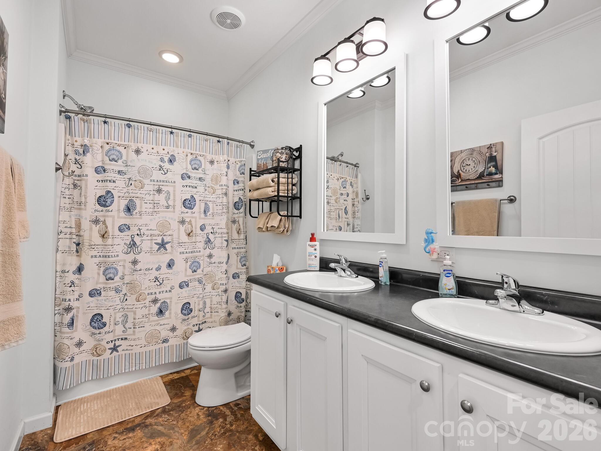 241 West Sunset Ridge Drive Etowah, NC 28729 - Photo 22 of 30 a bathroom with a granite countertop sink a toilet a mirror a shower and a bathtub
