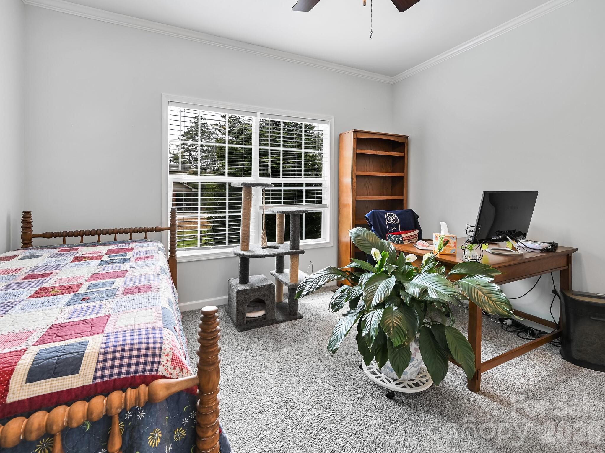 241 West Sunset Ridge Drive Etowah, NC 28729 - Photo 24 of 30 a bedroom with a bed and a window