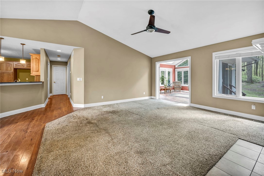 800 Bell Road Chagrin Falls, OH 44022 - Photo 4 of 35 Unfurnished living room with vaulted ceiling, a ceiling fan, and baseboards