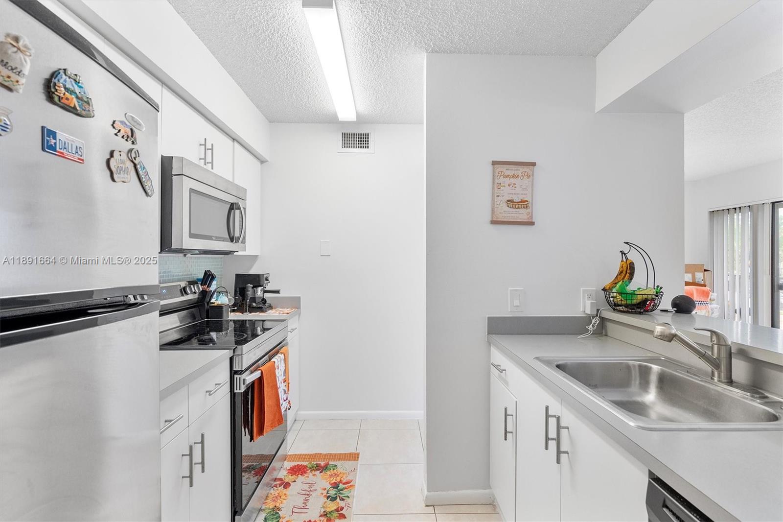 510 South Park Road, Unit 2510 Hollywood, FL 33021 - Photo 7 of 14 a kitchen with stainless steel appliances a sink a stove and a refrigerator
