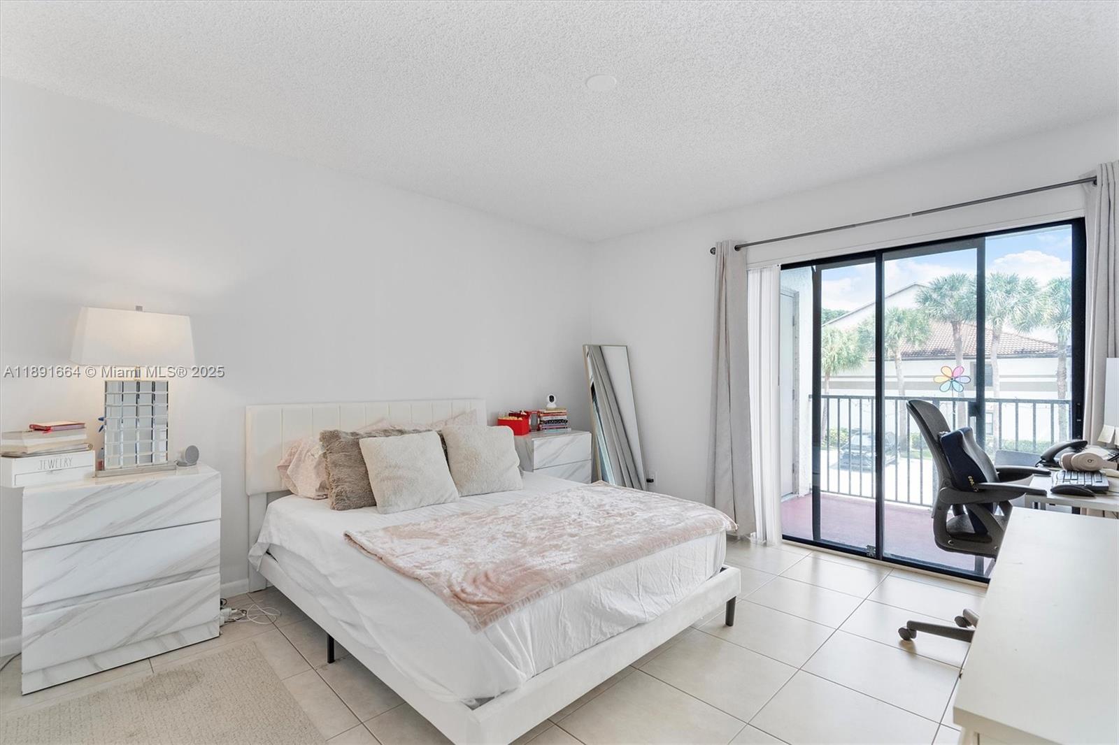 510 South Park Road, Unit 2510 Hollywood, FL 33021 - Photo 9 of 14 a bedroom with a bed and large windows