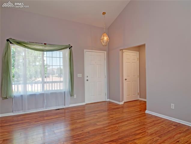 7680 Tompkins Road Peyton, CO 80831 - Photo 8 of 30 Living Room. Front door and door to the garage
