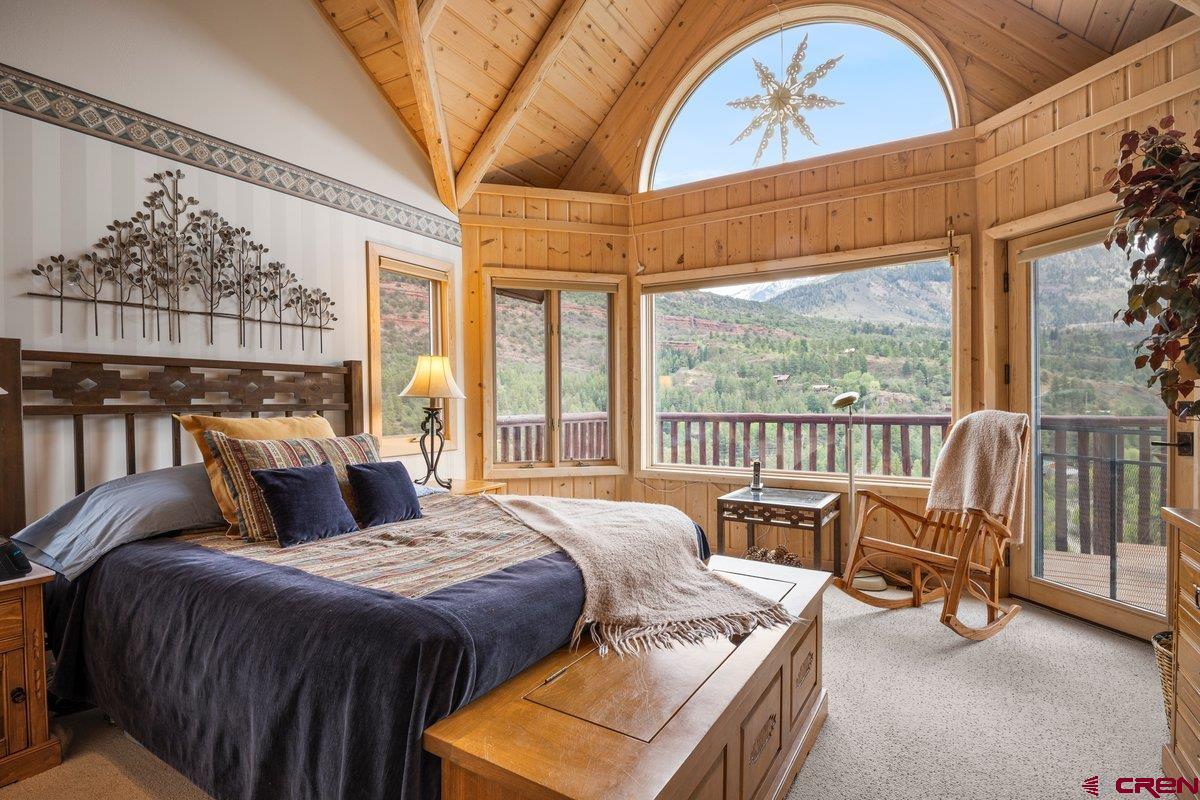2490 County Road 17 Ridgway, CO 81432 - Photo 22 of 26 a bedroom with a bed a couch and large window