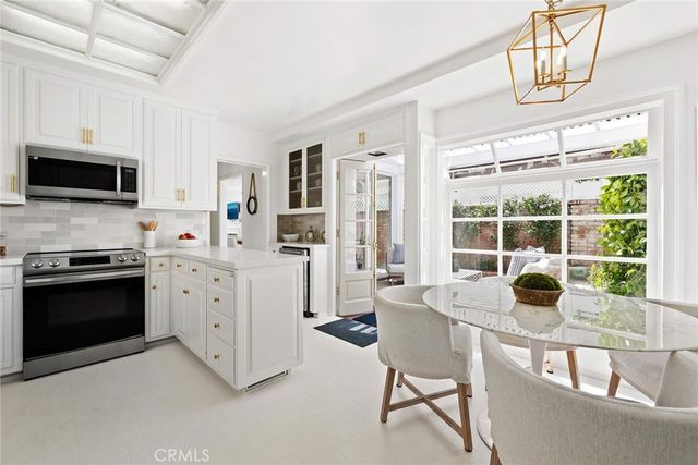 a kitchen with stainless steel appliances a stove a sink and a microwave