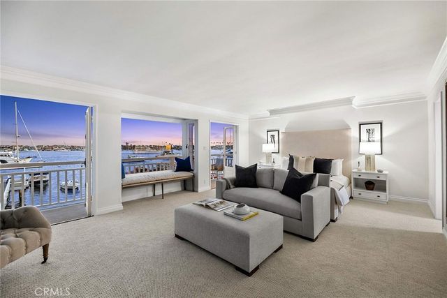 a living room with furniture and a kitchen view