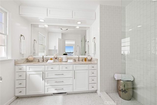 a bathroom with a double vanity sink a mirror and a