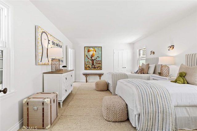 a bedroom with two beds and a large mirror