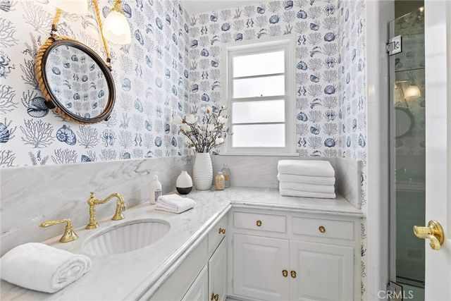 a bathroom with a sink and a mirror