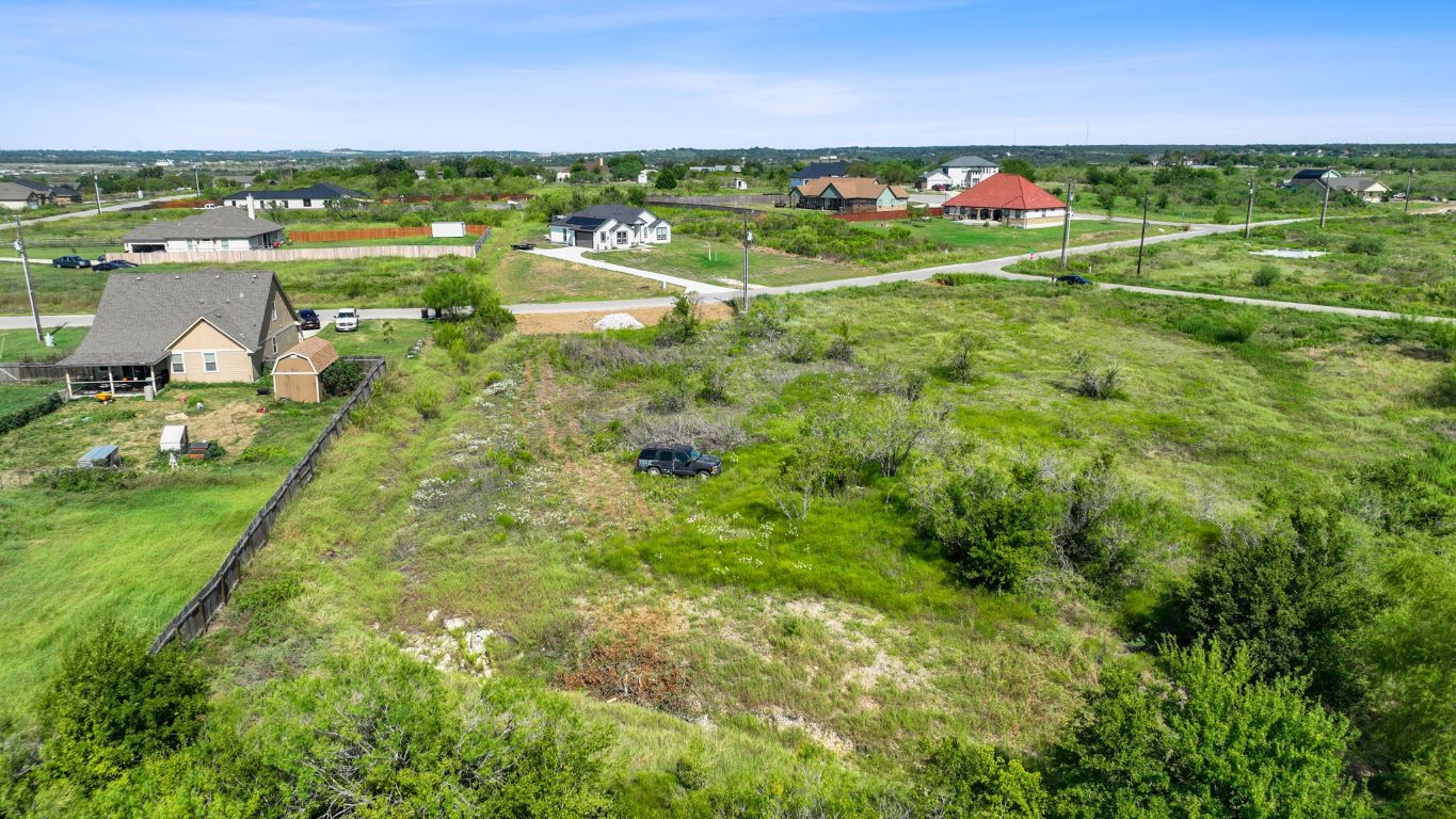 296 East Ridge Lane Kyle, TX 78640 - Photo 10 of 16 a view of a green field with lots of buildings in the background