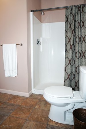 88 Fearing Hill Road Wareham, MA 02576 - Photo 17 of 29 a white toilet sitting next to a shower curtain