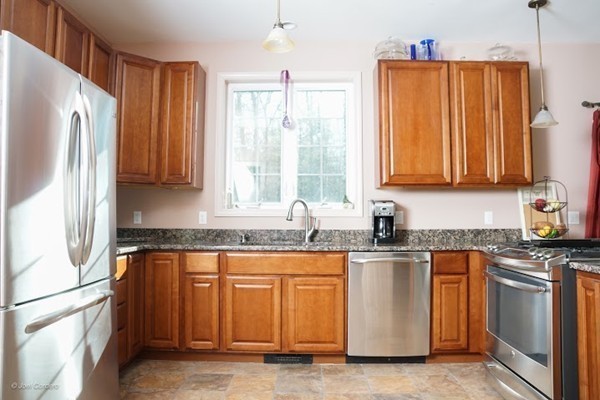 88 Fearing Hill Road Wareham, MA 02576 - Photo 3 of 29 a kitchen with stainless steel appliances granite countertop a sink a stove and a refrigerator