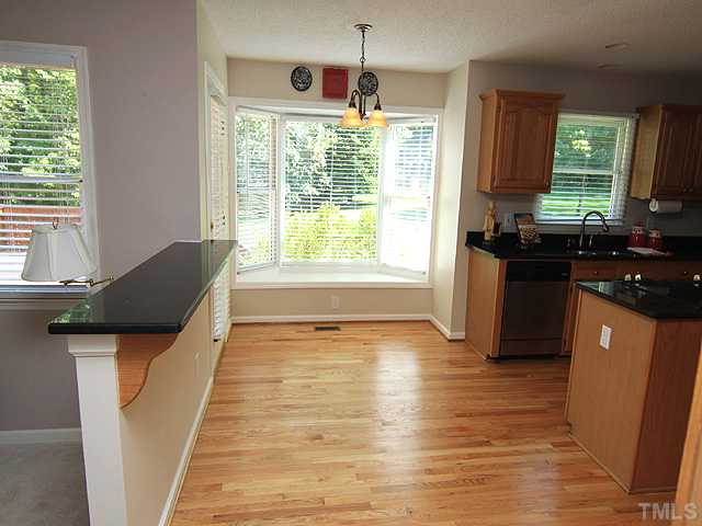 115 Equestrian Chase Rougemont, NC 27572 - Photo 5 of 12 a kitchen with granite countertop a stove a sink and a window