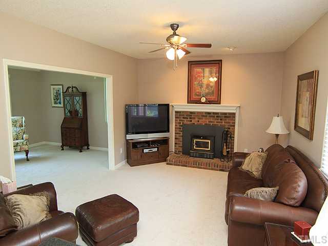 115 Equestrian Chase Rougemont, NC 27572 - Photo 6 of 12 a living room with furniture a fireplace and a flat screen tv