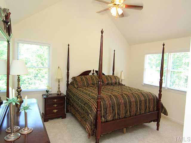 115 Equestrian Chase Rougemont, NC 27572 - Photo 7 of 12 a bedroom with a bed and a chandelier