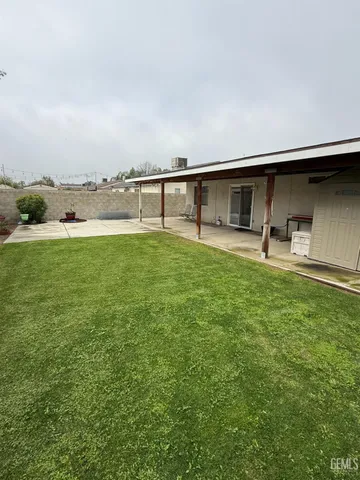 a backyard of a house with table and chairs