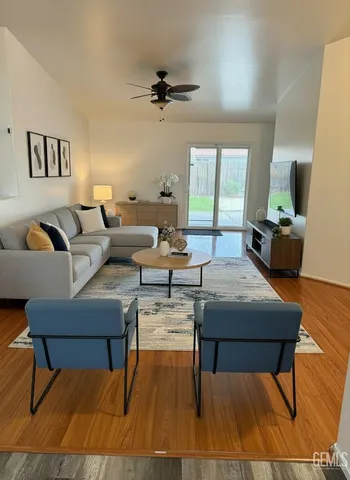 a living room with furniture and a wooden floor