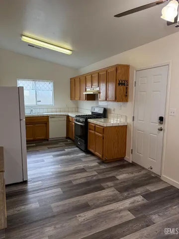 a kitchen with stainless steel appliances granite countertop a sink and stove top oven