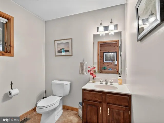 a spacious bathroom with a double vanity sink a mirror and a bathtub