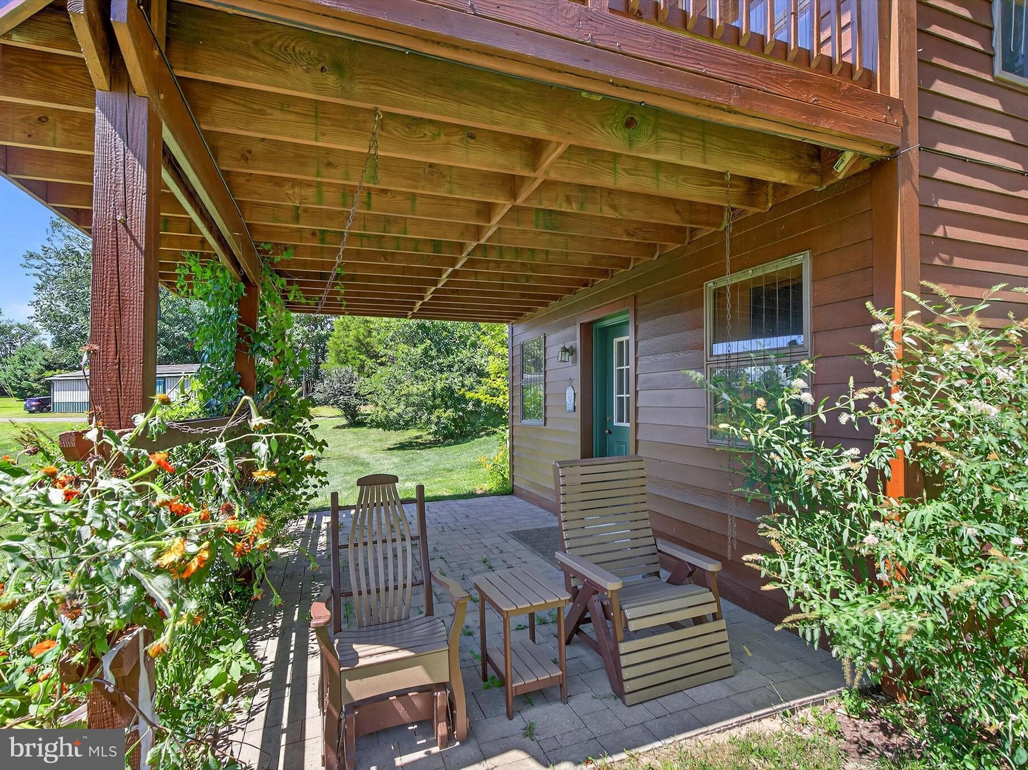 1494 Mountain Road Orrtanna, PA 17353 - Photo 63 of 80 a view of a patio with table and chairs potted plants with wooden floor