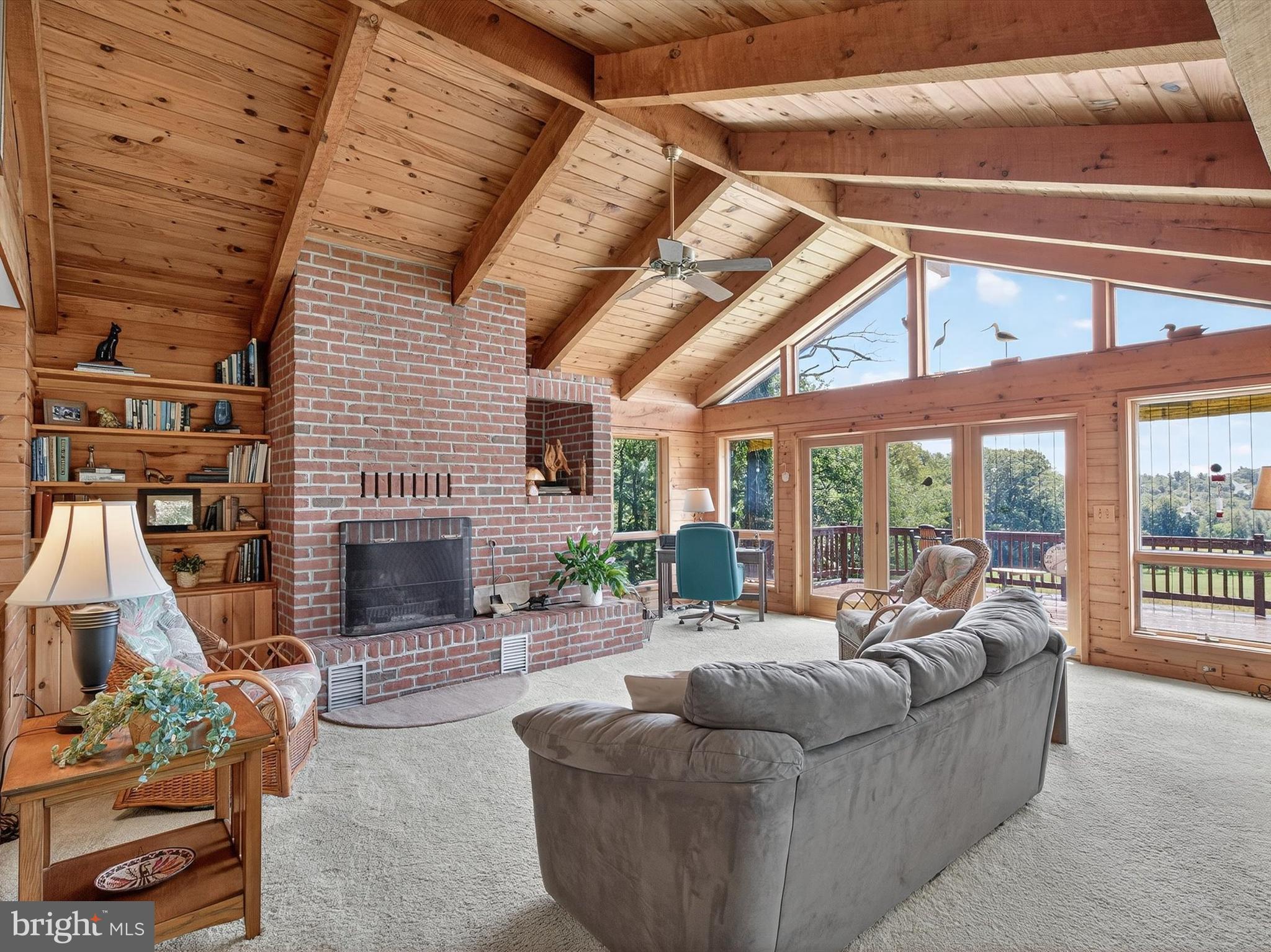 1494 Mountain Road Orrtanna, PA 17353 - Photo 7 of 80 a living room with furniture a fireplace and a floor to ceiling window