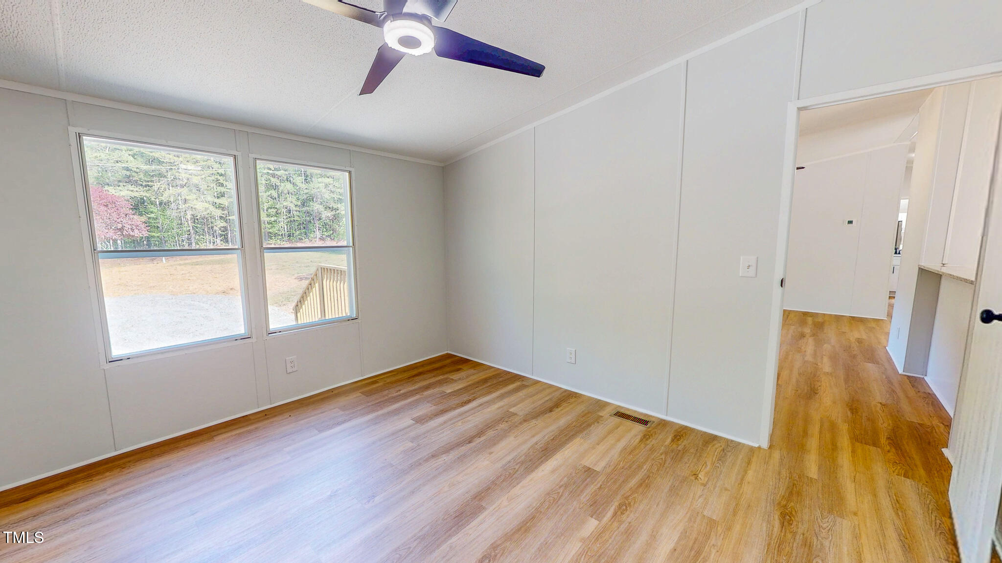1622 Julian Oakley Road Rougemont, NC 27572 - Photo 11 of 30 a view of empty room with wooden floor and fan
