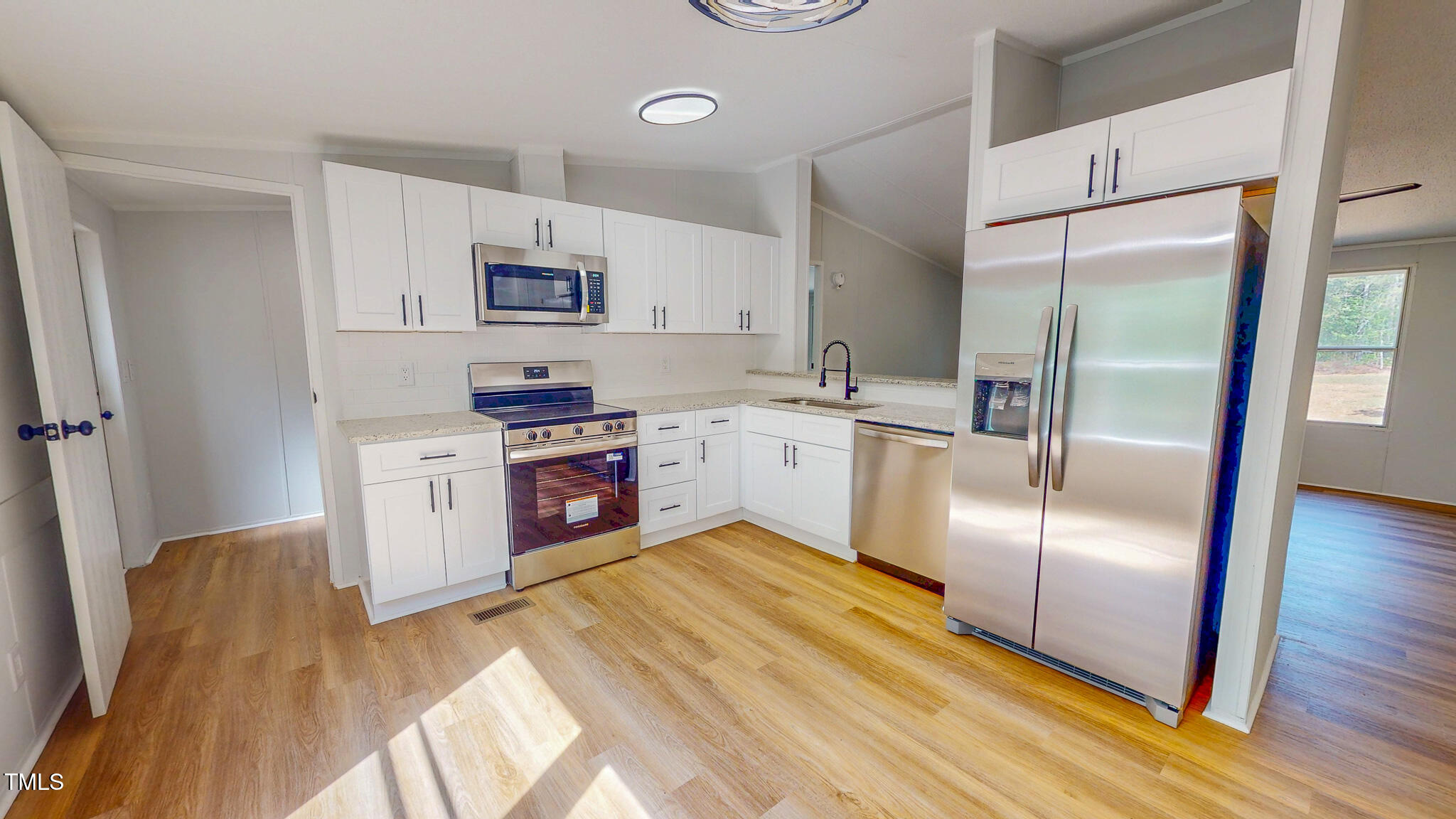 1622 Julian Oakley Road Rougemont, NC 27572 - Photo 2 of 30 a kitchen with stainless steel appliances granite countertop a refrigerator a sink a stove and white cabinets with wooden floor
