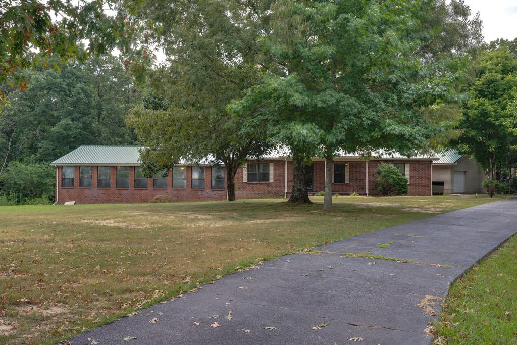 200 Coble Road Hohenwald, TN 38462 - Photo 3 of 29 a front view of a house with a garden