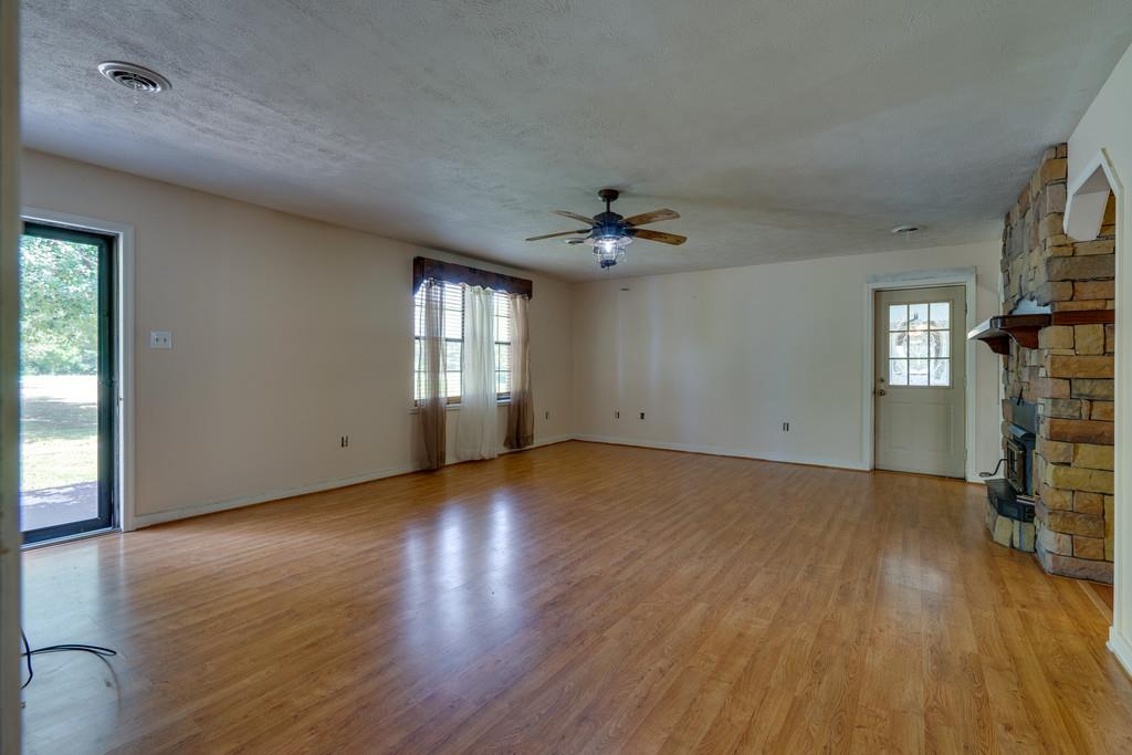 200 Coble Road Hohenwald, TN 38462 - Photo 7 of 29 an empty room with wooden floor and windows