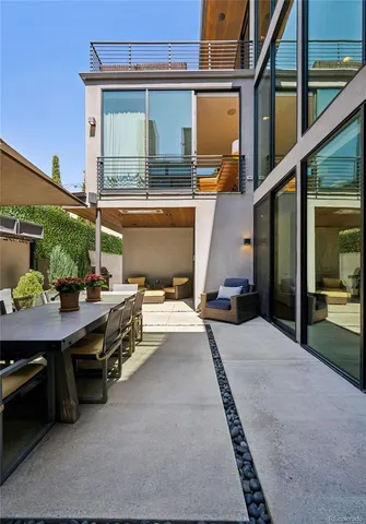 a balcony with furniture and a potted plant