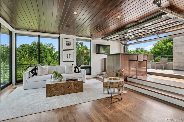 a living room with patio furniture and a large window