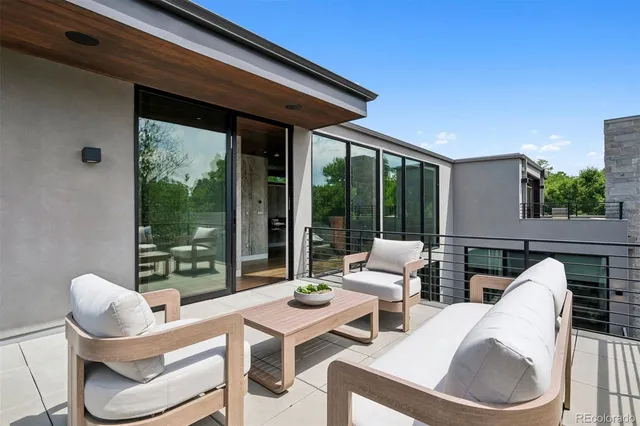 a view of a patio with dining table and chairs