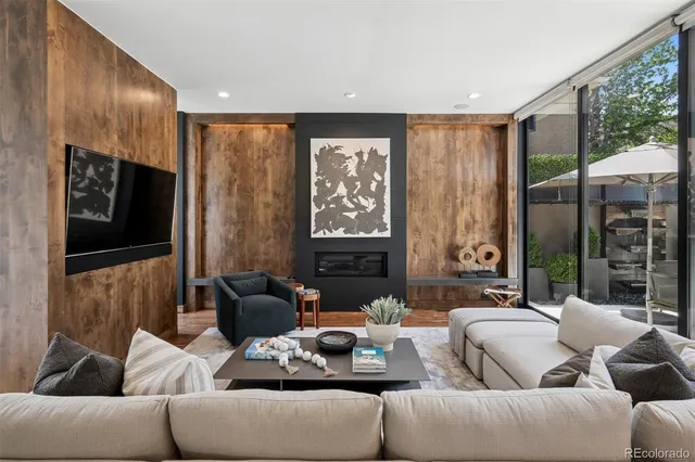 a living room with furniture tv and a large window